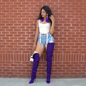 Waist high purple satin boots.
